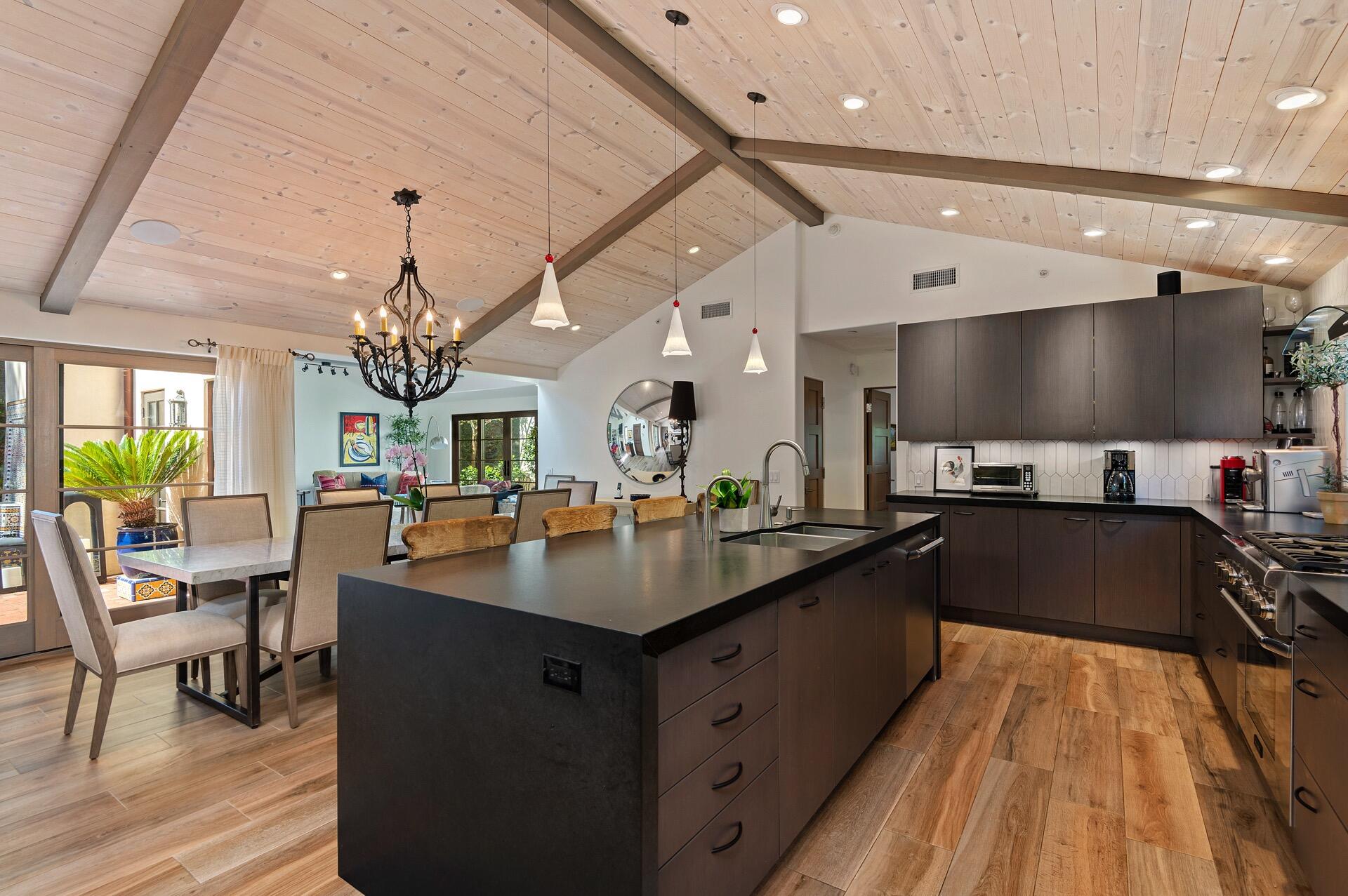 Undisclosed Address Montecito, CA 93108 - Photo 2 of 33 a large kitchen with stainless steel appliances a large counter top a stove and a chandelier