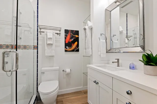 a bathroom with a sink toilet and shower