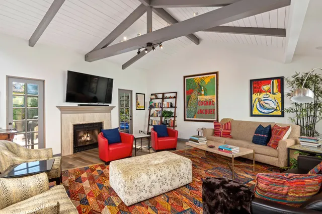 a living room with furniture a flat screen tv and a fireplace