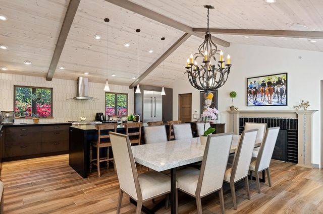 a view of a dining room with furniture wooden floor and chandelier