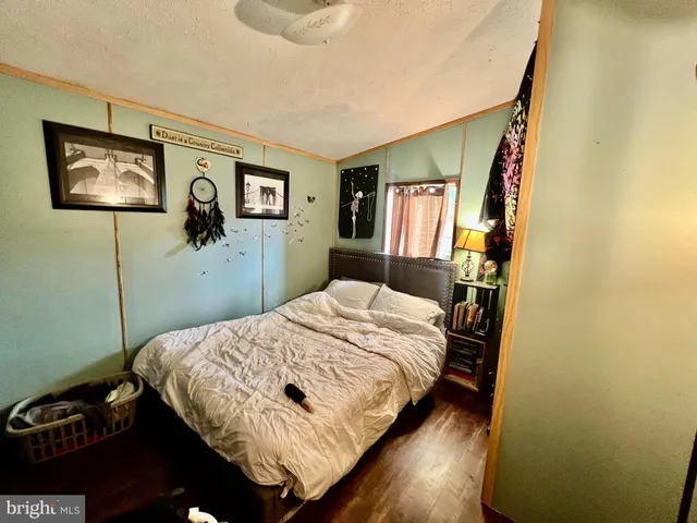 a bedroom with a bed and a desk