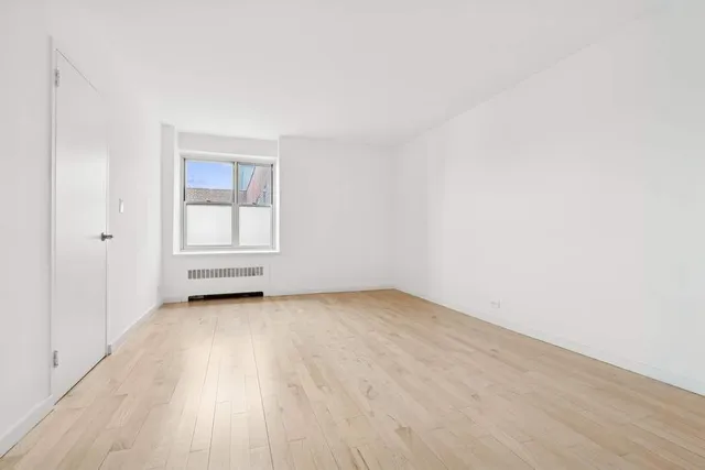 a bedroom with bed and window