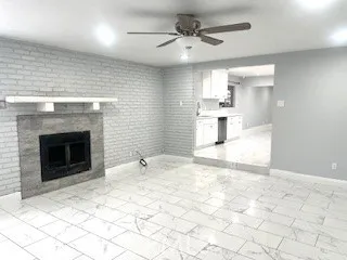 a view of a kitchen with a fireplace and a chandelier