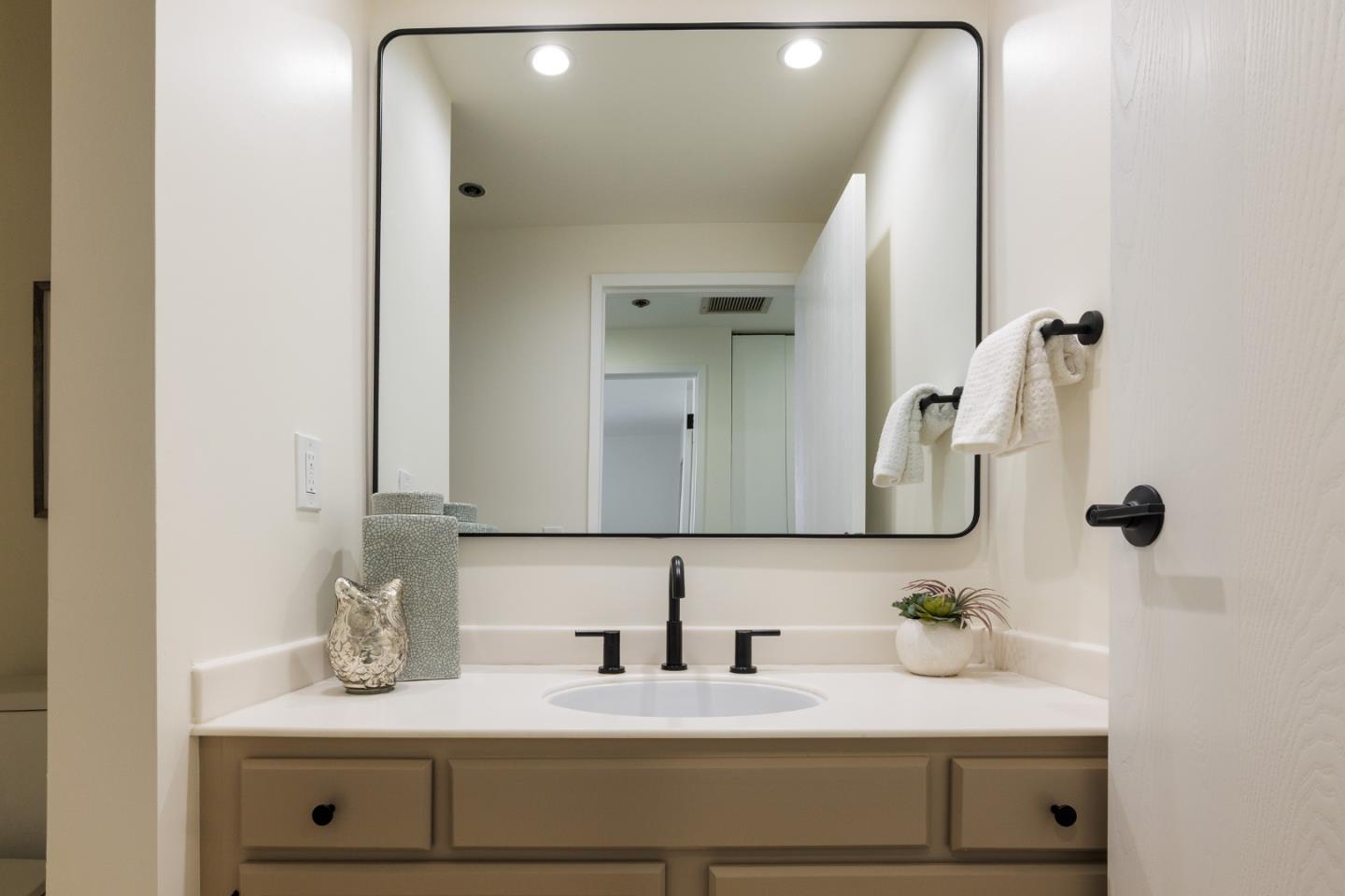 110 Park Road, Unit 202 Burlingame, CA 94010 - Photo 14 of 31 a bathroom with a granite countertop sink and a mirror