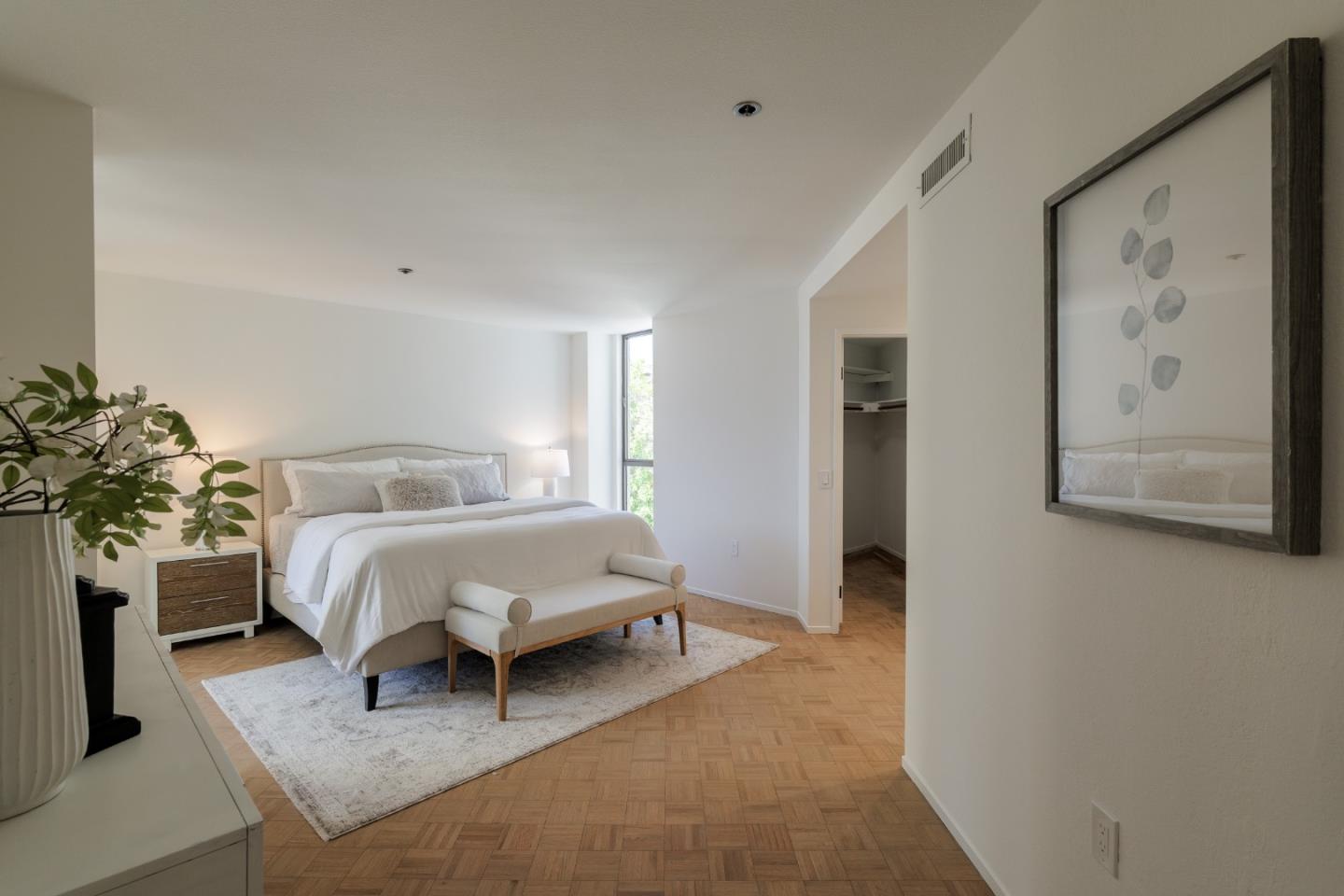 110 Park Road, Unit 202 Burlingame, CA 94010 - Photo 16 of 31 a spacious bedroom with a bed and a couch
