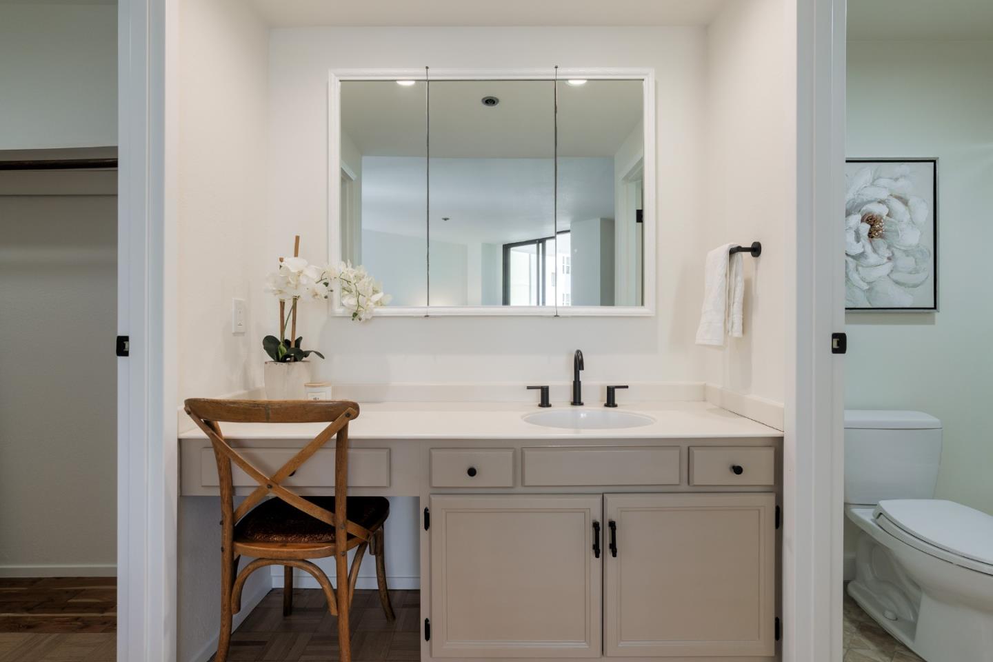 110 Park Road, Unit 202 Burlingame, CA 94010 - Photo 19 of 31 a bathroom with a sink a toilet and a mirror