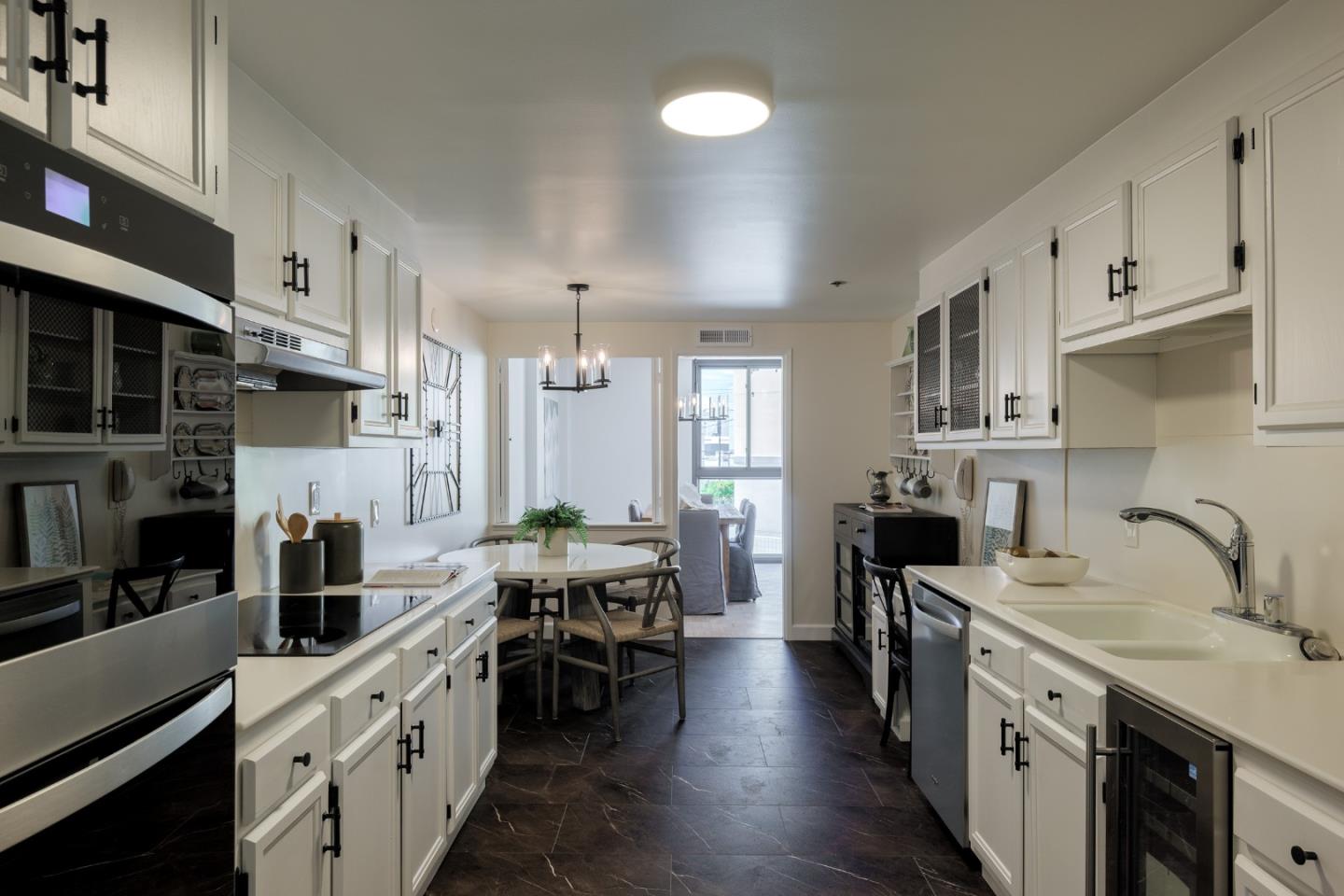 110 Park Road, Unit 202 Burlingame, CA 94010 - Photo 2 of 31 a kitchen with stainless steel appliances a sink stove and cabinets