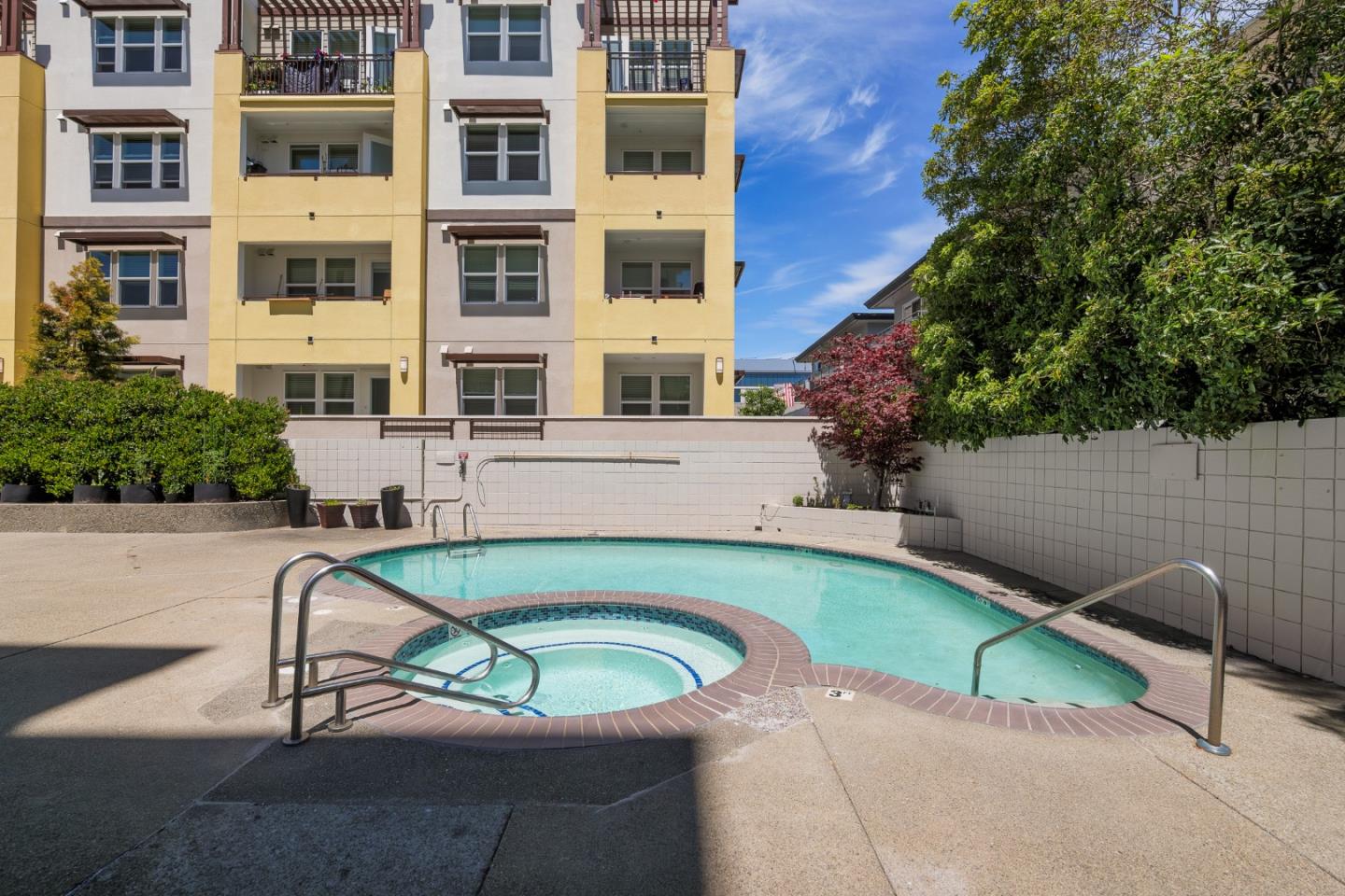 110 Park Road, Unit 202 Burlingame, CA 94010 - Photo 23 of 31 a view of a swimming pool with a lounge chair