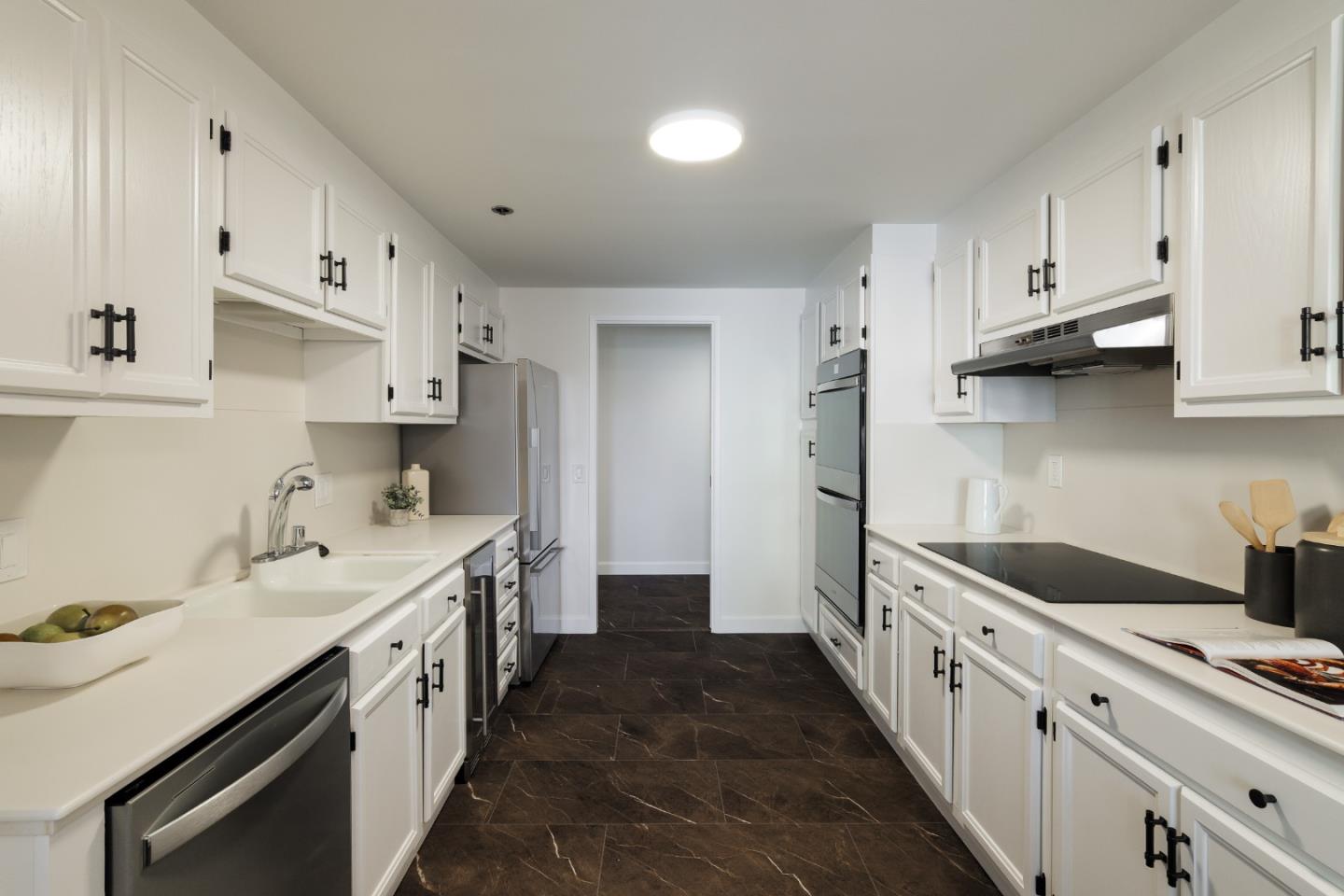 110 Park Road, Unit 202 Burlingame, CA 94010 - Photo 4 of 31 a kitchen with white cabinets sink and stove