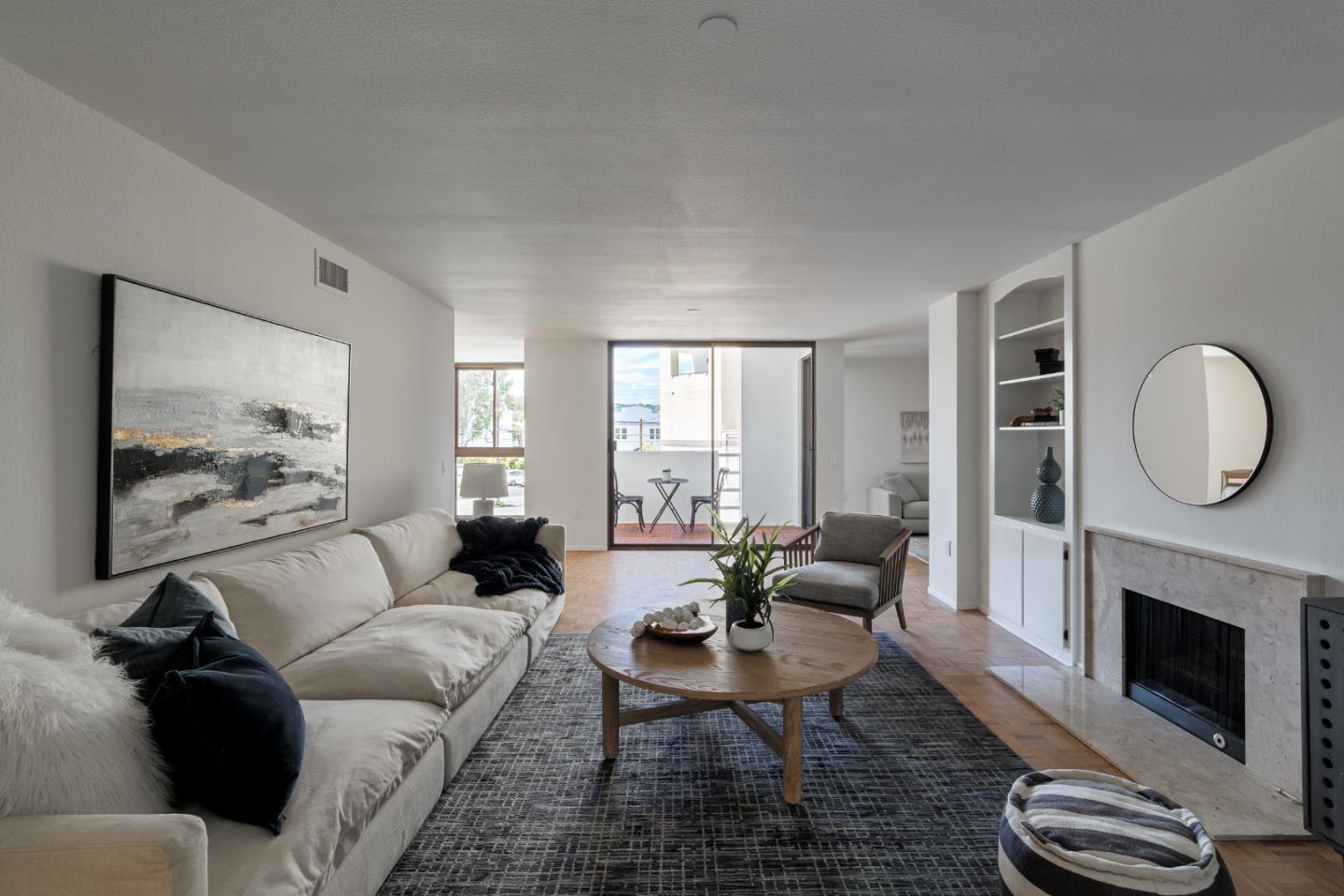 110 Park Road, Unit 202 Burlingame, CA 94010 - Photo 5 of 31 a living room with furniture a fireplace a rug and a window
