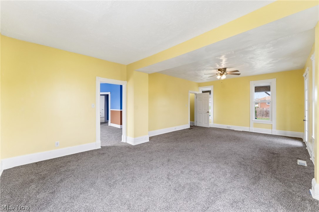 563 Geneva Avenue Struthers, OH 44471 - Photo 12 of 31 Spare room featuring carpet and a ceiling fan