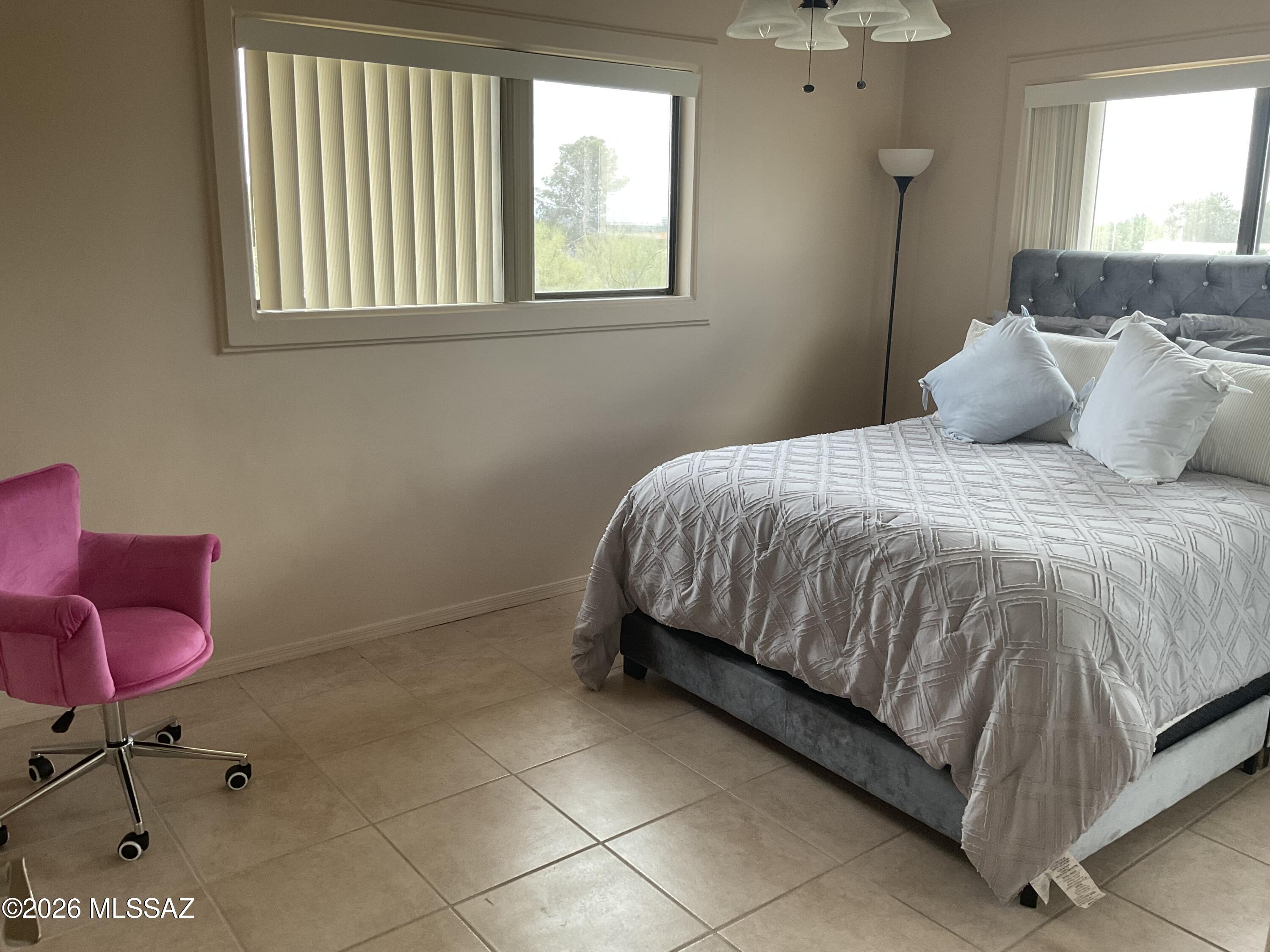 4060 North Swan Road Tucson, AZ 85718 - Photo 26 of 47 a bedroom with a bed and window