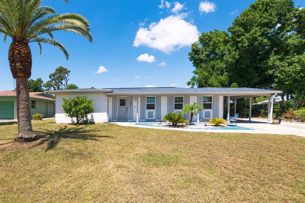 308 Salem Avenue Northwest Port Charlotte, FL 33952 - Photo 1 of 1 a view of a house with swimming pool and porch with furniture