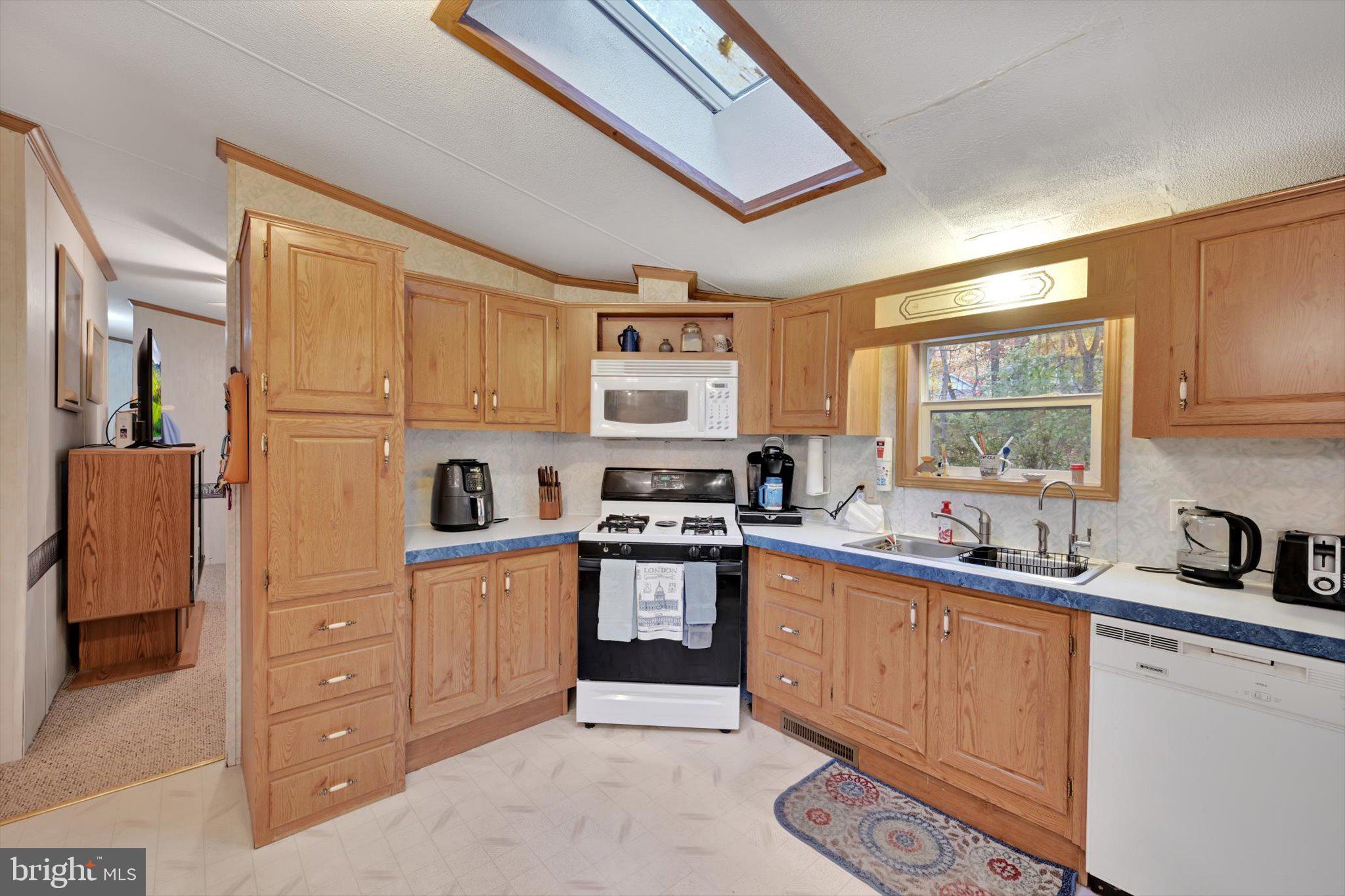 1104 Bedford Avenue Reading, PA 19607 - Photo 17 of 39 a kitchen with stainless steel appliances a sink a stove a refrigerator cabinets and a window