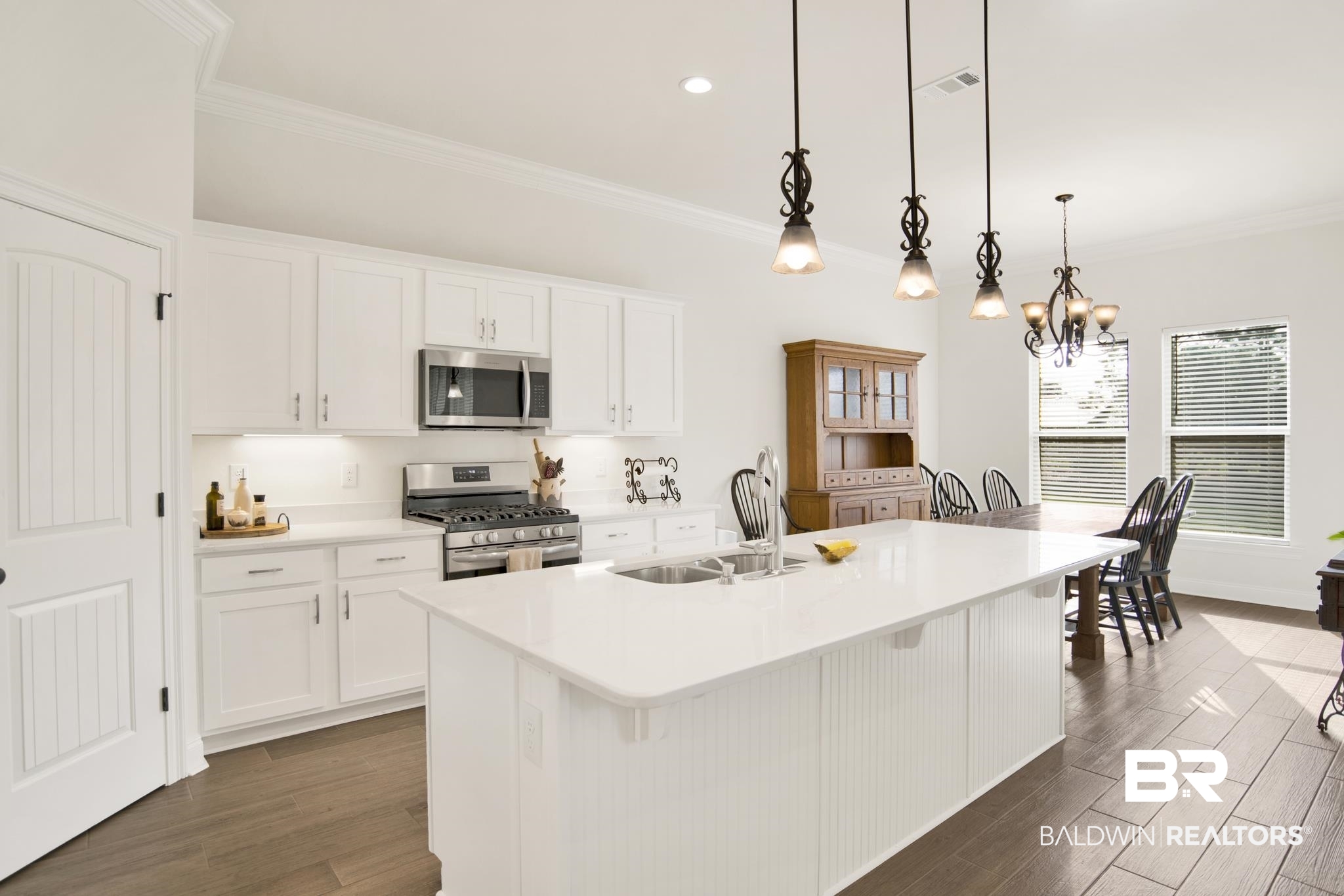22258 Hibiscus Circle Foley, AL 36535 - Photo 5 of 26 Kitchen featuring stainless steel appliances, dark wood-type flooring, visible vents, and crown molding