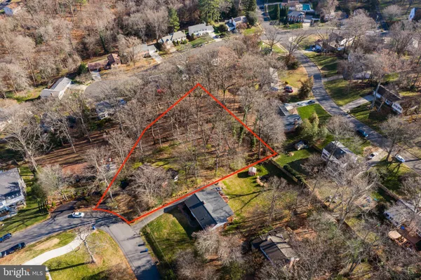an aerial view of a house with a mountain