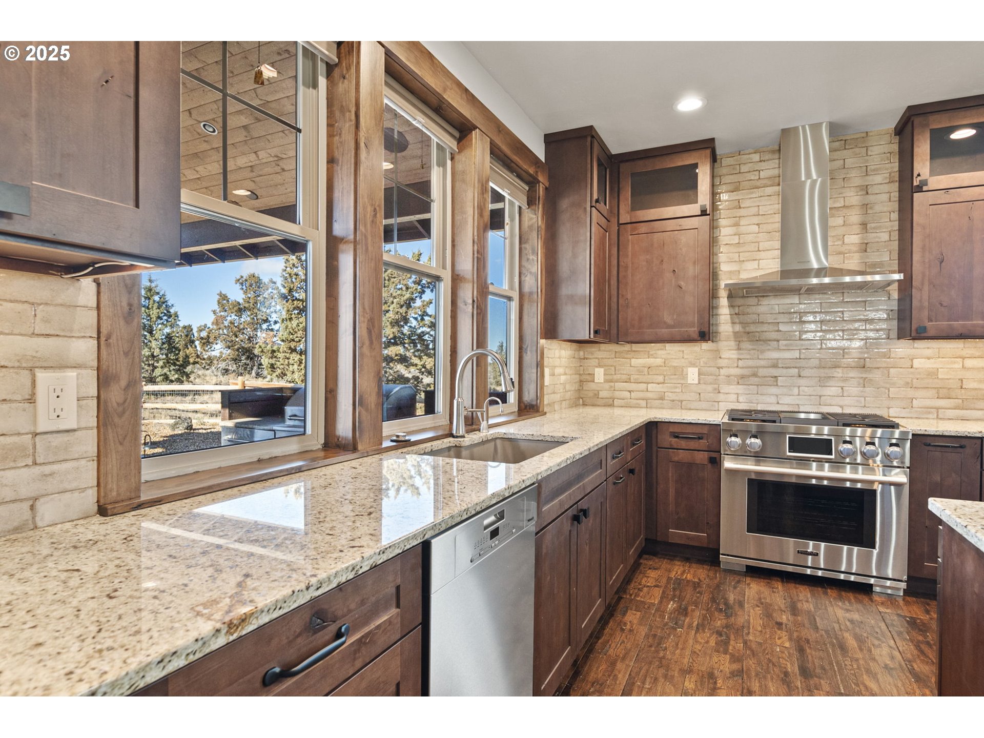 16660 Southwest Ranchview Court Powell Butte, OR 97753 - Photo 13 of 32 a kitchen with stainless steel appliances granite countertop a stove a sink and a microwave