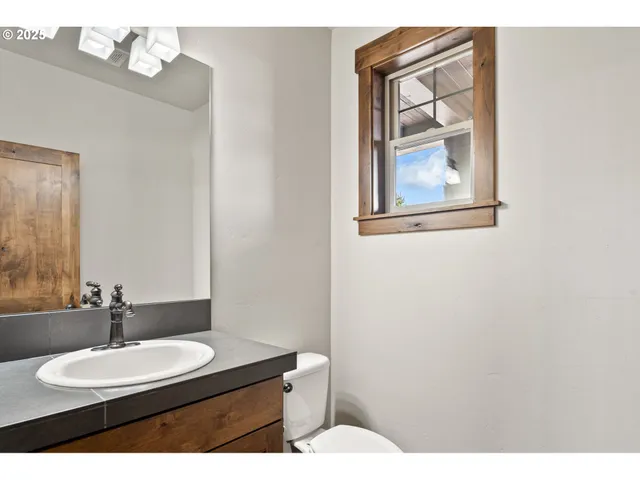 a bathroom with a toilet a sink and mirror