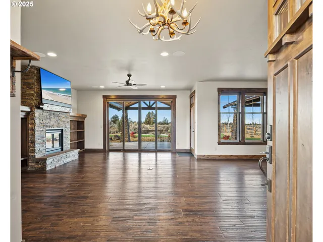 an empty room with wooden floor and a fireplace