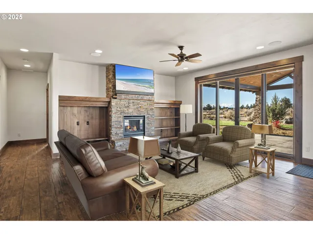 a living room with furniture fireplace and a large window