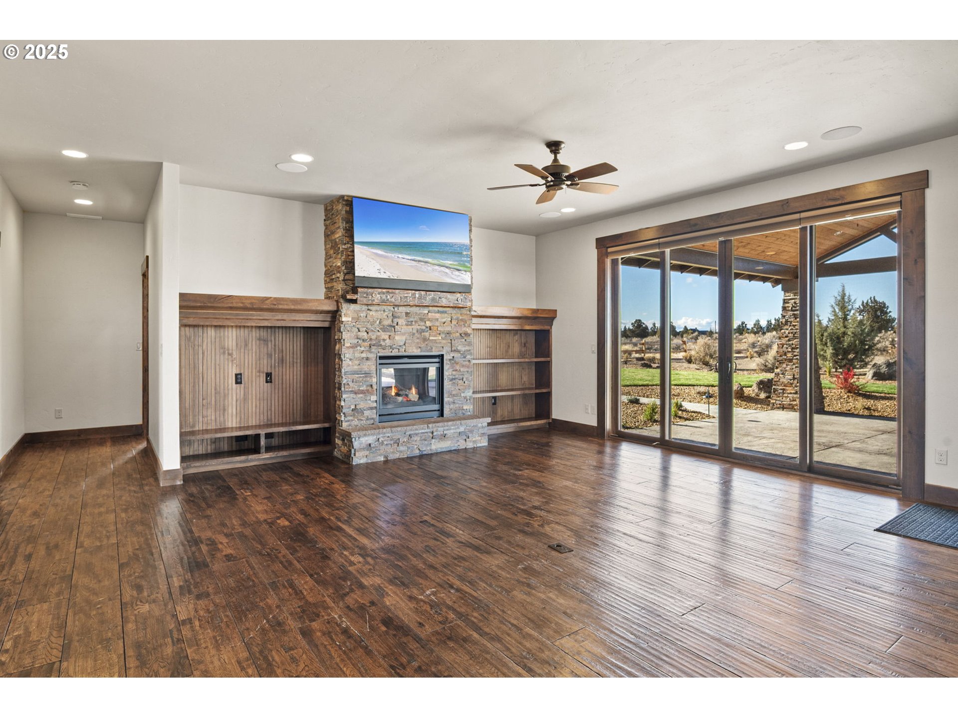 16660 Southwest Ranchview Court Powell Butte, OR 97753 - Photo 7 of 32 a view of empty room with wooden floor and fan
