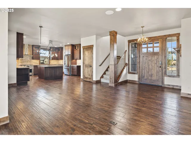 a view of a living room kitchen and a wooden floor