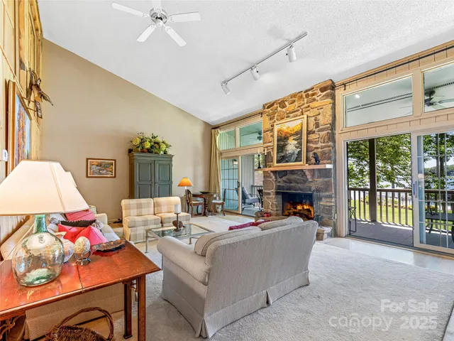 a living room with furniture fireplace and a large window