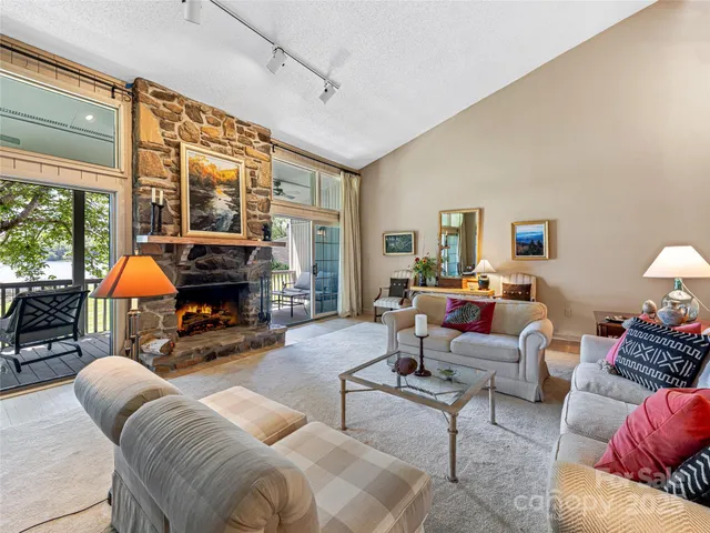 a living room with furniture a fireplace and a table