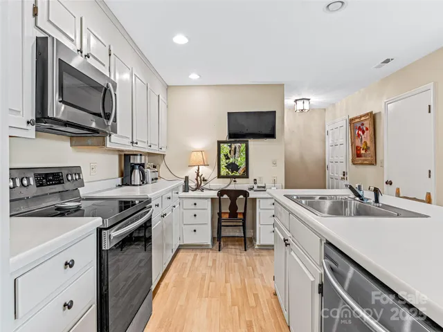 a kitchen with a sink stove and microwave