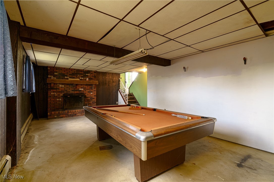 6747 Giddings Road Rootstown, OH 44272 - Photo 22 of 39 Recreation Room featuring wood paneling and fireplace