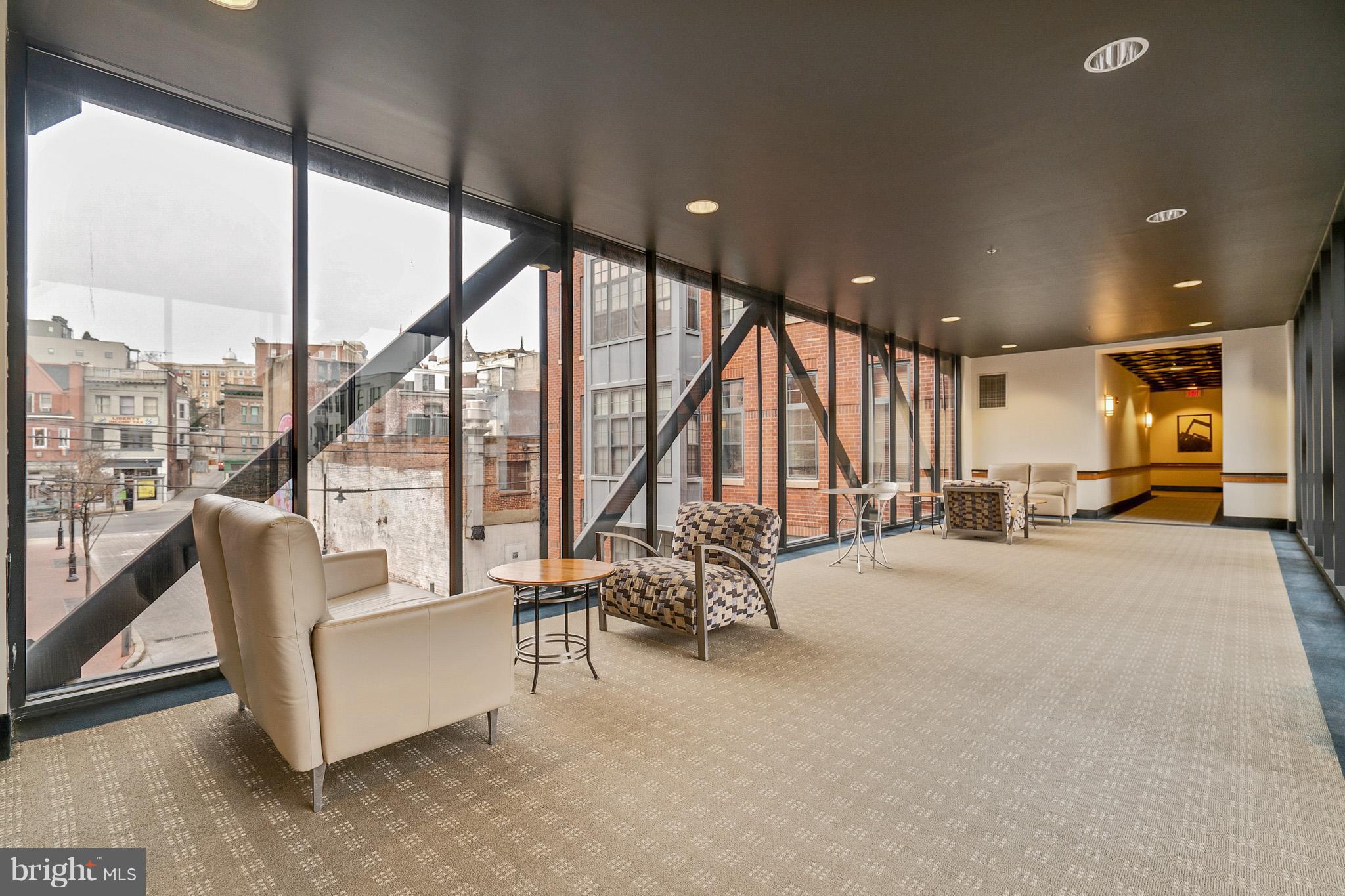 2328 Champlain Street Northwest, Unit 329 Washington, DC 20009 - Photo 13 of 25 a living room with furniture and large windows