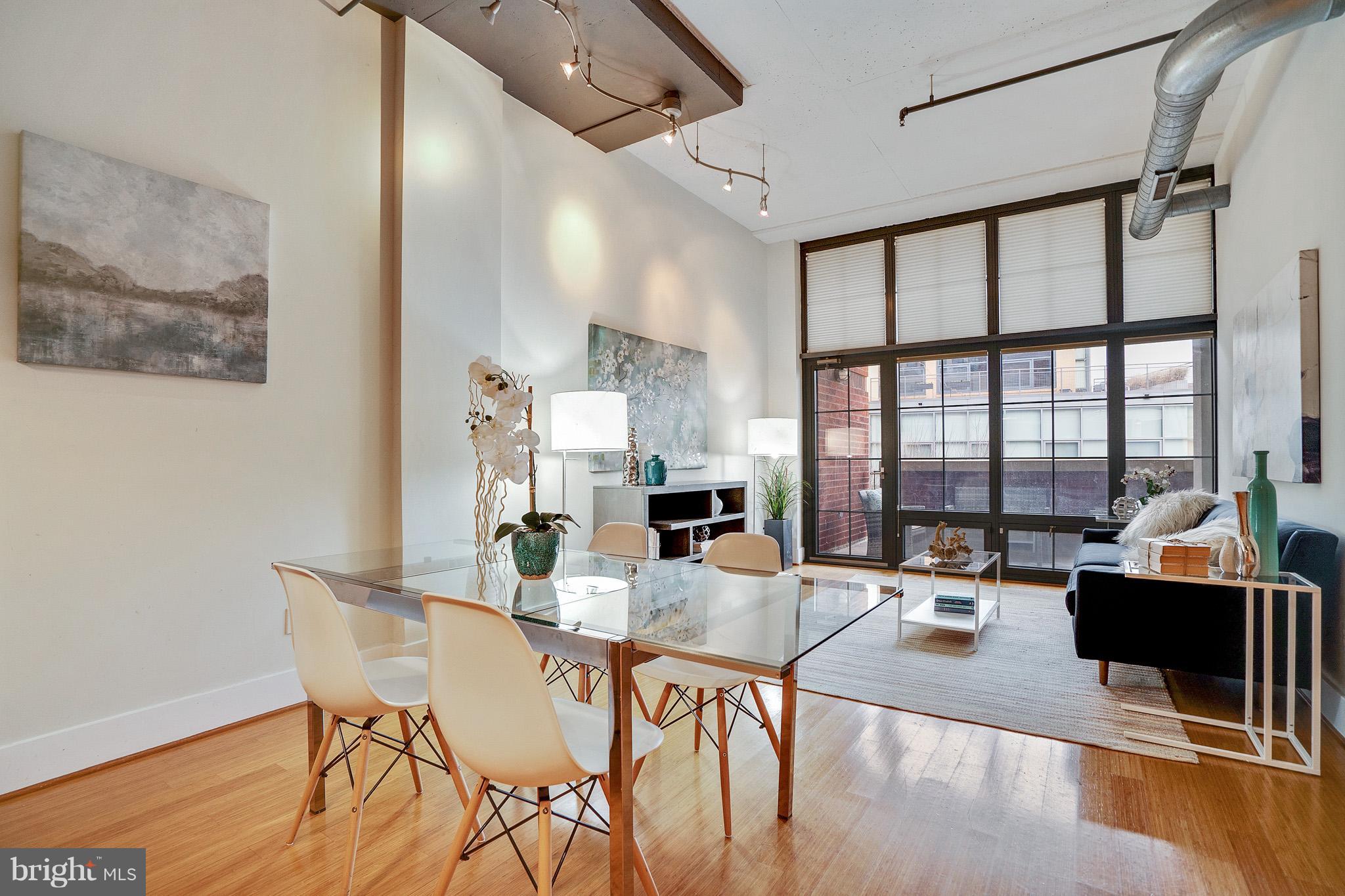 2328 Champlain Street Northwest, Unit 329 Washington, DC 20009 - Photo 3 of 25 a view of a dining room with furniture window and wooden floor