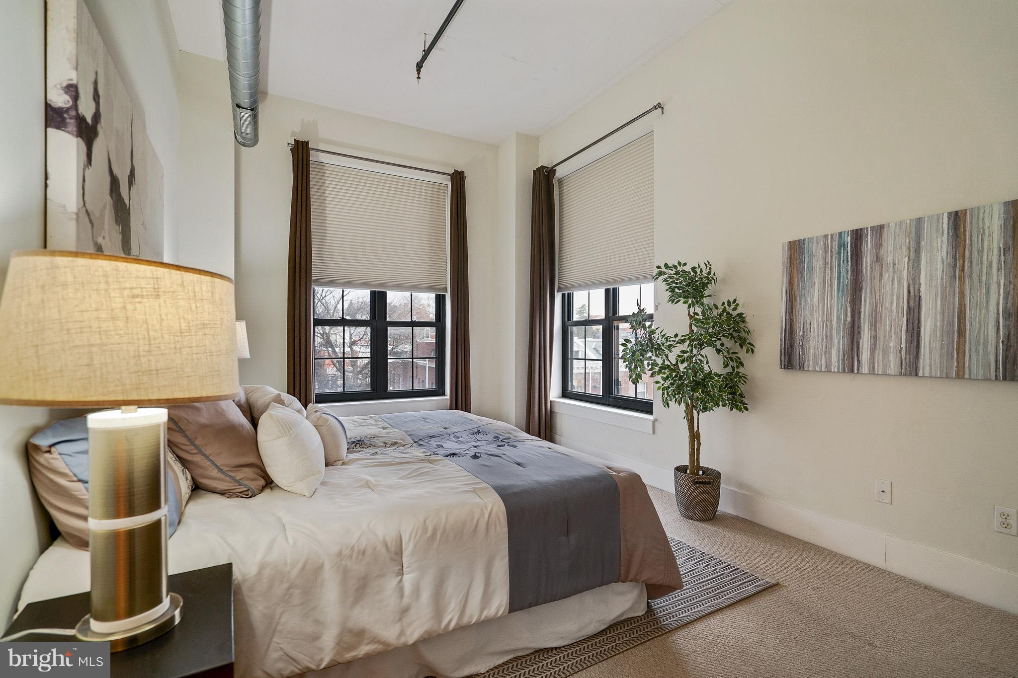 2328 Champlain Street Northwest, Unit 329 Washington, DC 20009 - Photo 5 of 25 a bedroom with a bed and chair