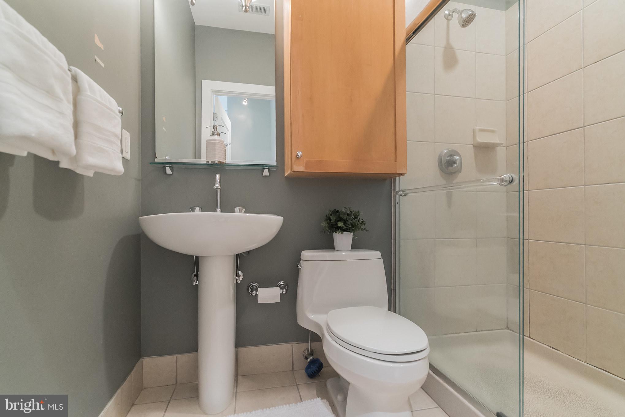 2328 Champlain Street Northwest, Unit 329 Washington, DC 20009 - Photo 7 of 25 a bathroom with a toilet sink and mirror