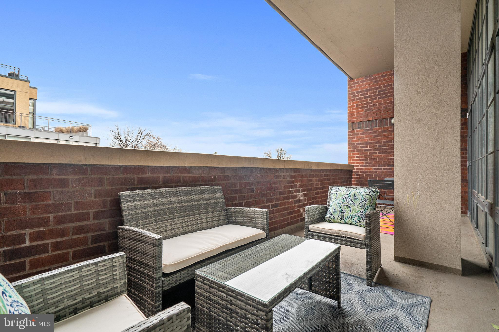 2328 Champlain Street Northwest, Unit 329 Washington, DC 20009 - Photo 9 of 25 a view of a roof deck with couches and sky view