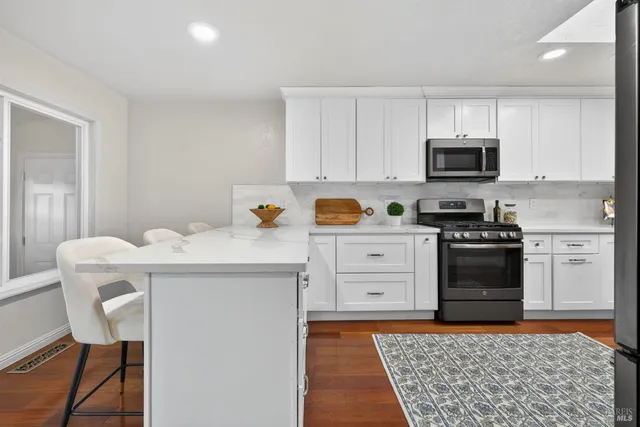 a kitchen with stainless steel appliances a refrigerator sink and stove