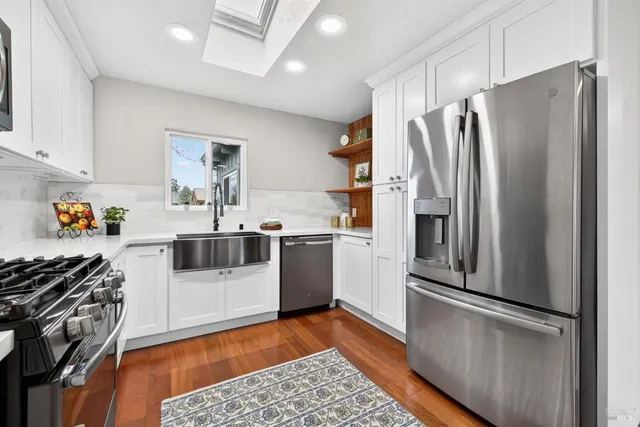 a spacious bathroom with double vanity and a window