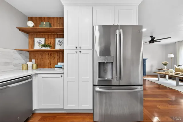 a bathroom with a granite countertop sink toilet and a mirror