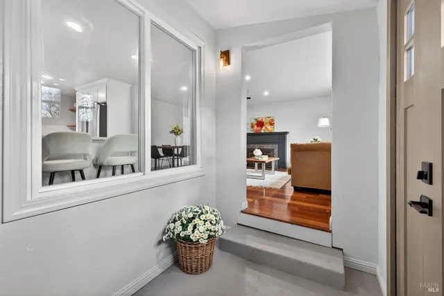 a living room with furniture and view of kitchen