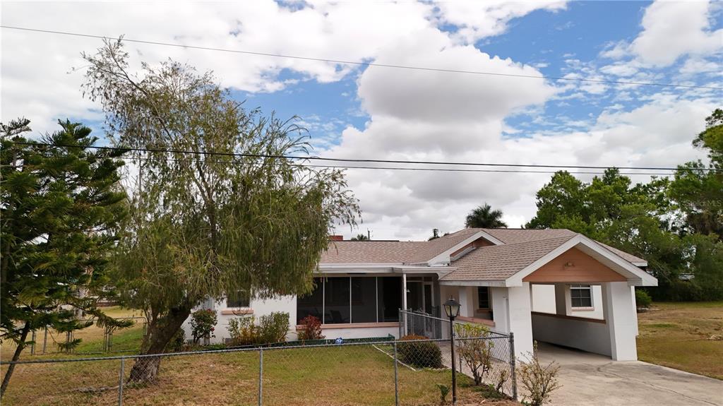 6386 Scott Street Punta Gorda, FL 33950 - Photo 15 of 40 a front view of a house with garden