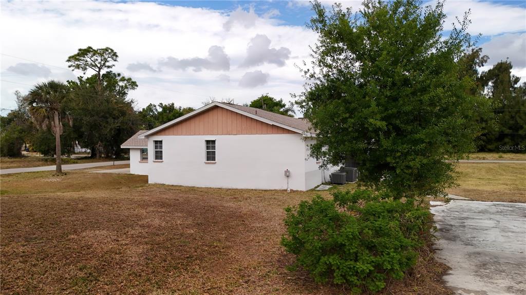 6386 Scott Street Punta Gorda, FL 33950 - Photo 21 of 40 a view of a house with a yard and large trees