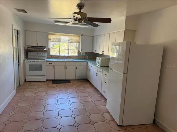 a kitchen with cabinets and window