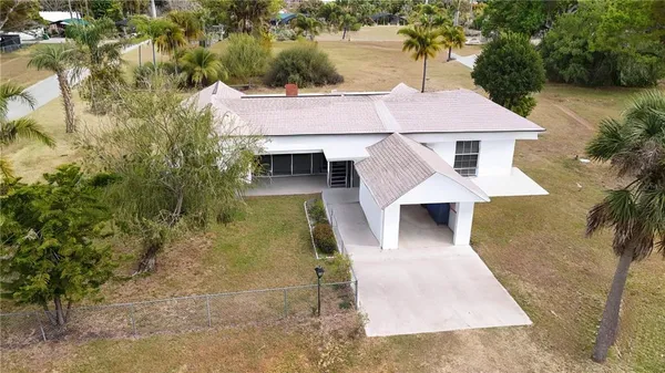 an aerial view of a house with yard