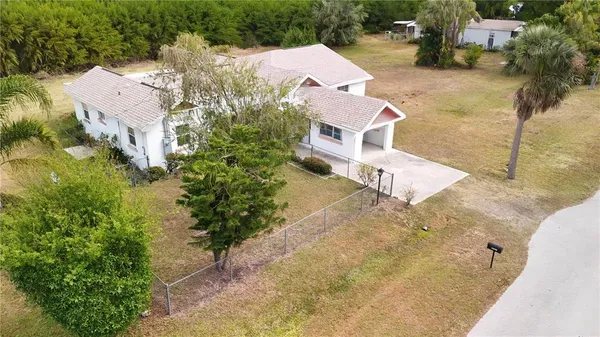a aerial view of a house with swimming pool and large trees