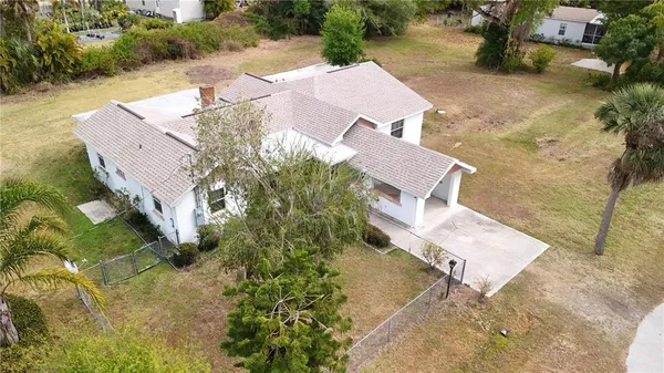 an aerial view of a house with yard and street view