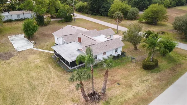 an aerial view of a house with garden space and lake view