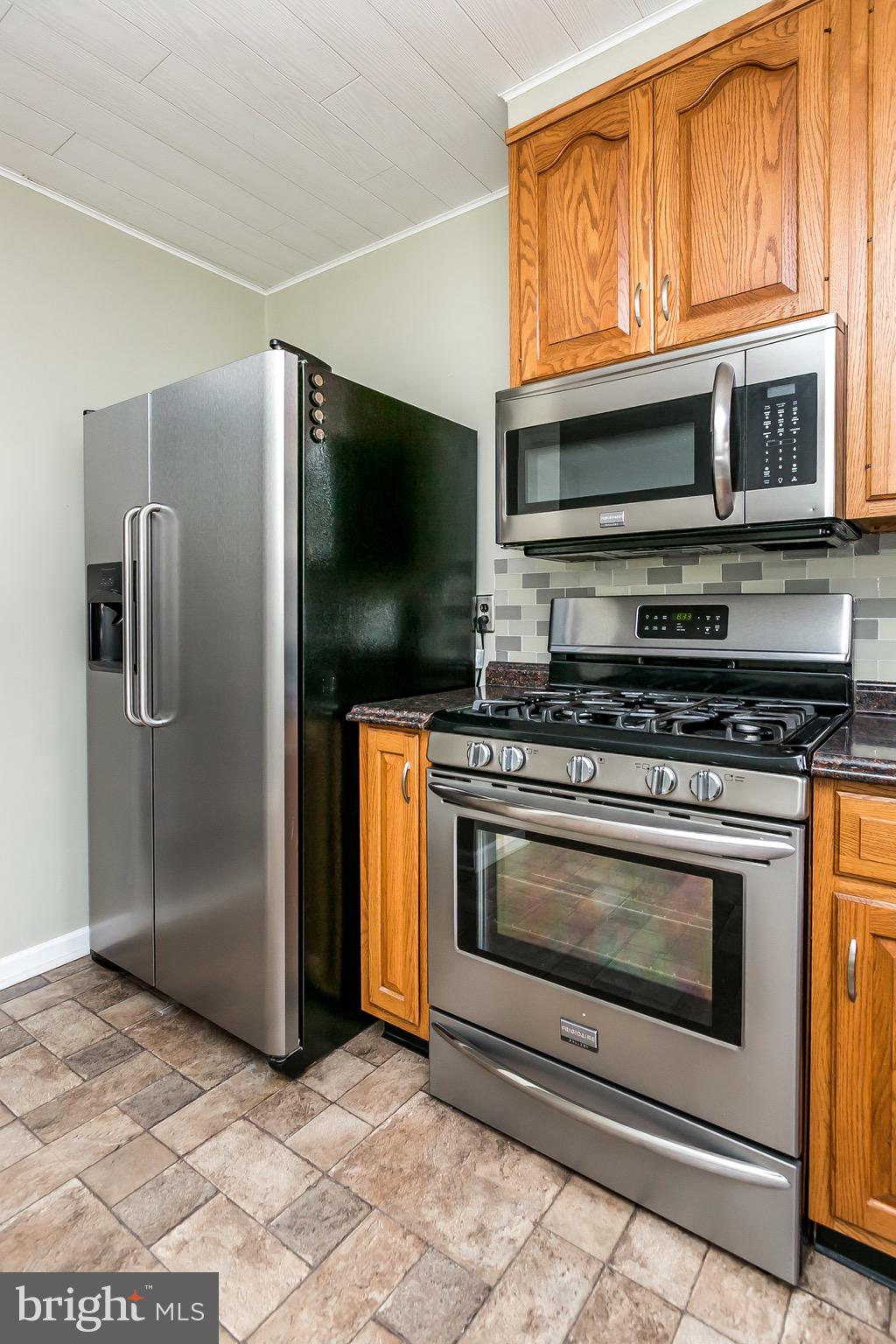 1315 Webster Street Baltimore, MD 21230 - Photo 14 of 29 a kitchen with stainless steel appliances a stove a microwave and a refrigerator
