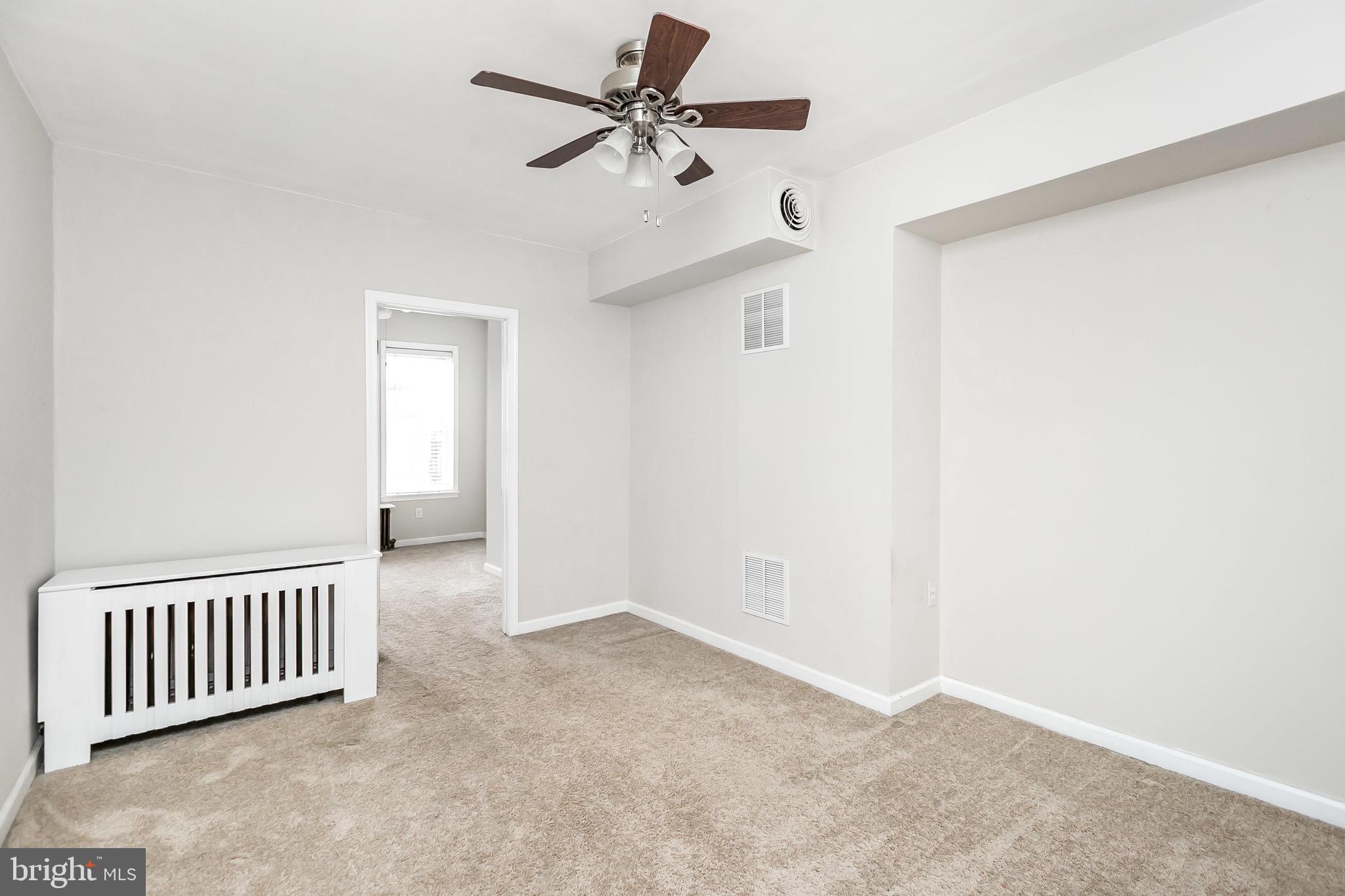 1315 Webster Street Baltimore, MD 21230 - Photo 21 of 29 an empty room with a ceiling fan and a window
