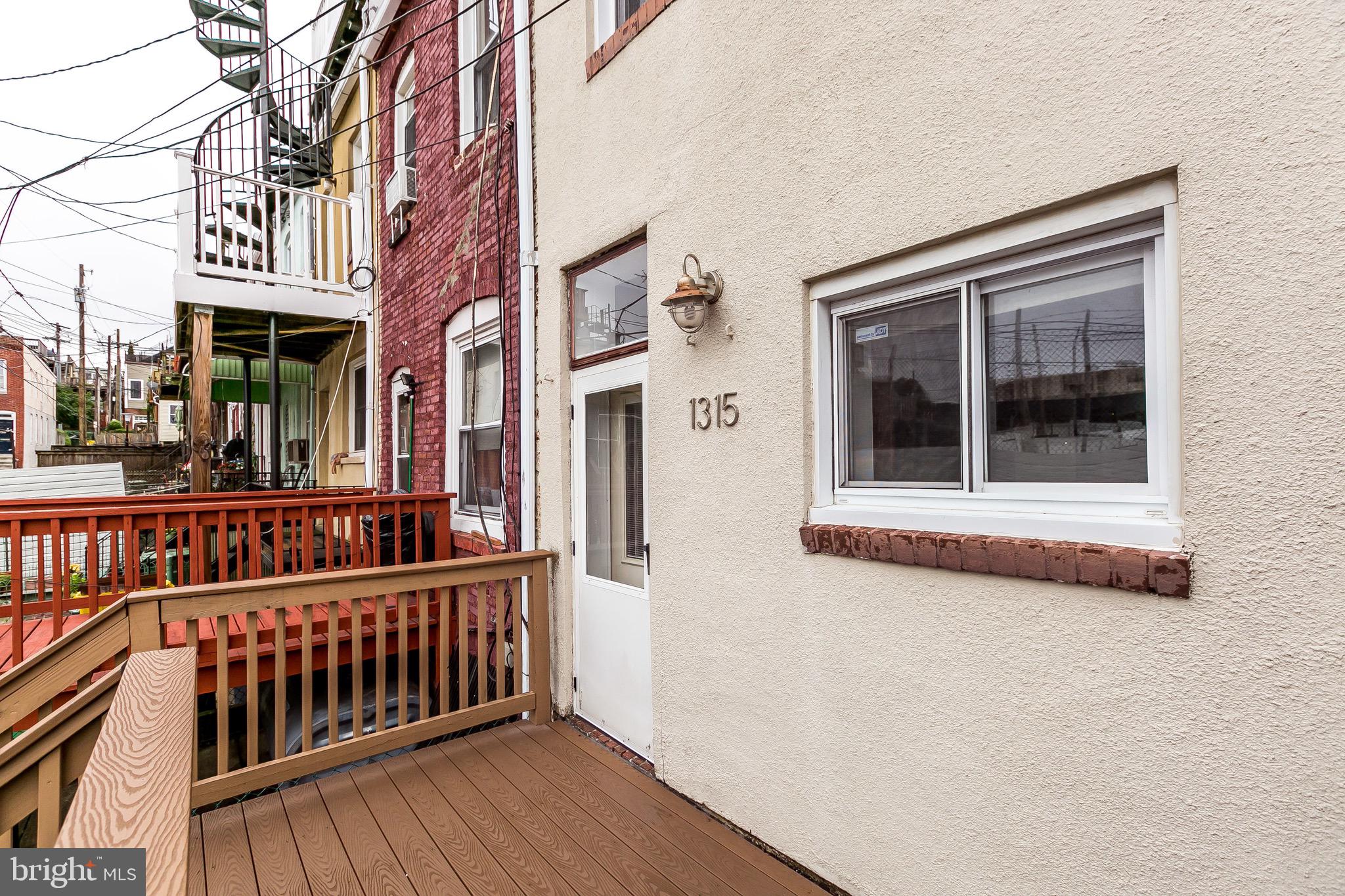 1315 Webster Street Baltimore, MD 21230 - Photo 28 of 29 a view of a brick house with many windows