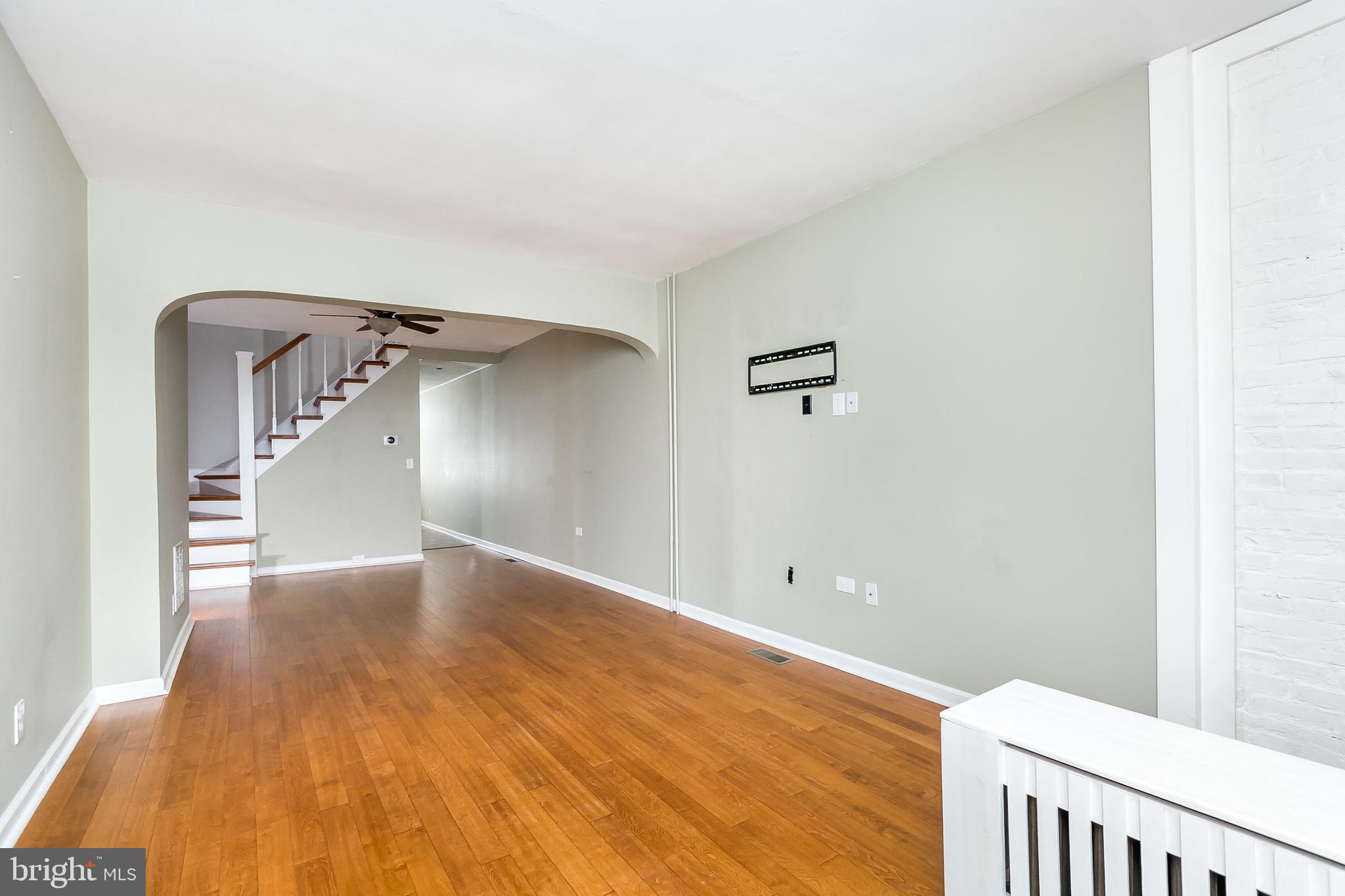 1315 Webster Street Baltimore, MD 21230 - Photo 8 of 29 a view of a room with wooden floor and a ceiling fan